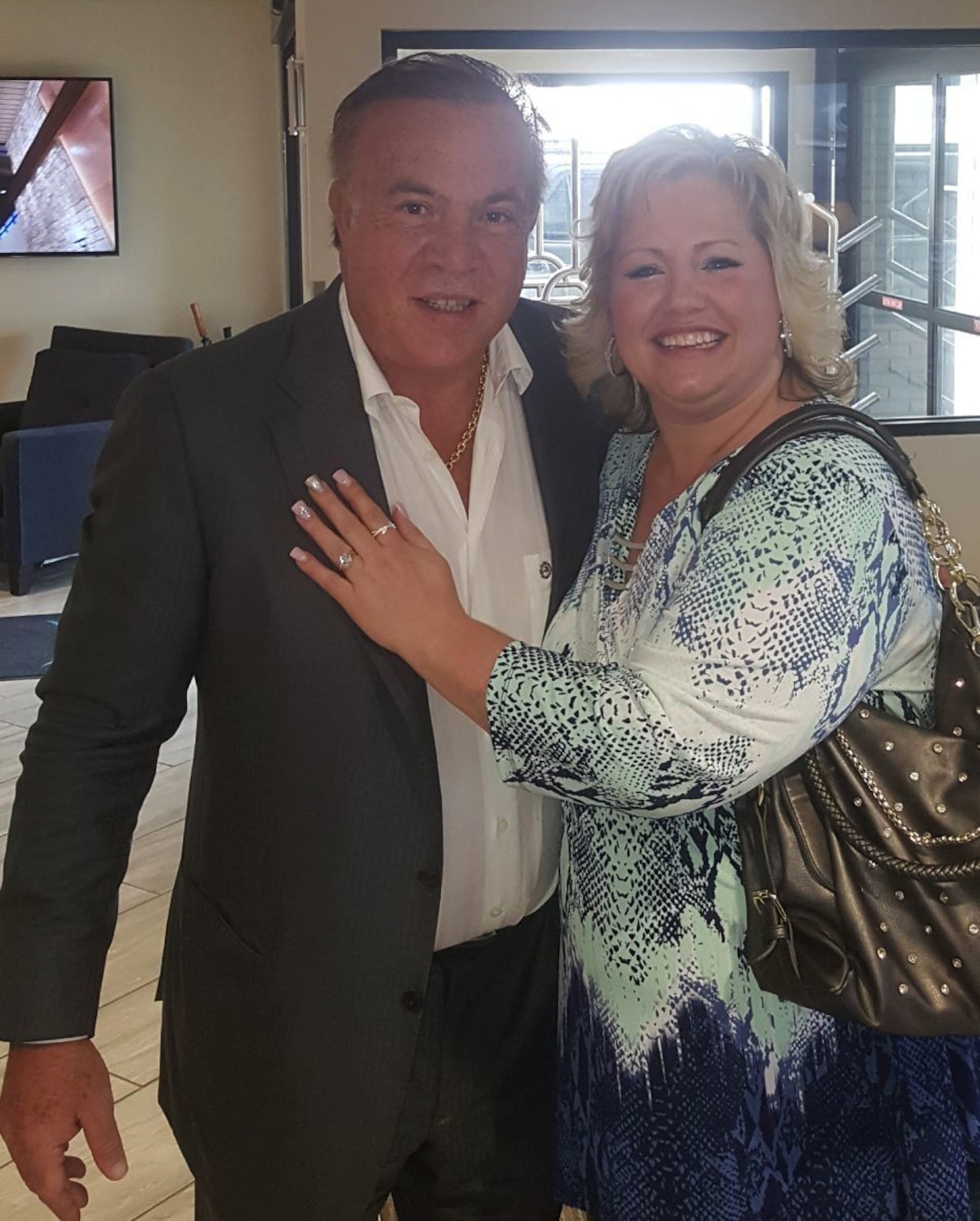 This Oct. 2017 photo taken by Jason Holt and released by his wife Laurie Holt, shows her posing for a photo with Wilmer Ruperti at a private jet airport in Salt Lake City, Utah. Laurie and Jason Holt say they are just grateful for the help being given by Ruperti, a wealthy Venezuelan businessman, after 16 months of confinement for their son Joshua Holt, who has been accused by government prosecutors of stockpiling weapons in a bizarre case that supporters say was a set up to retaliate against the U.S. as tensions between Washington and Caracas rise. (Jason Holt via AP)