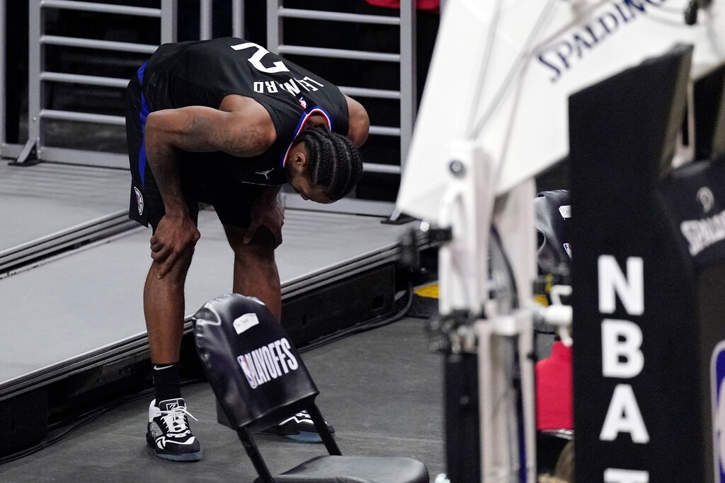 (Mark J. Terrill | AP) Los Angeles Clippers forward Kawhi Leonard holds his knee after stepping awkwardly during the second half in Game 4 of a second-round NBA basketball playoff series against the Utah Jazz Monday, June 14, 2021, in Los Angeles.