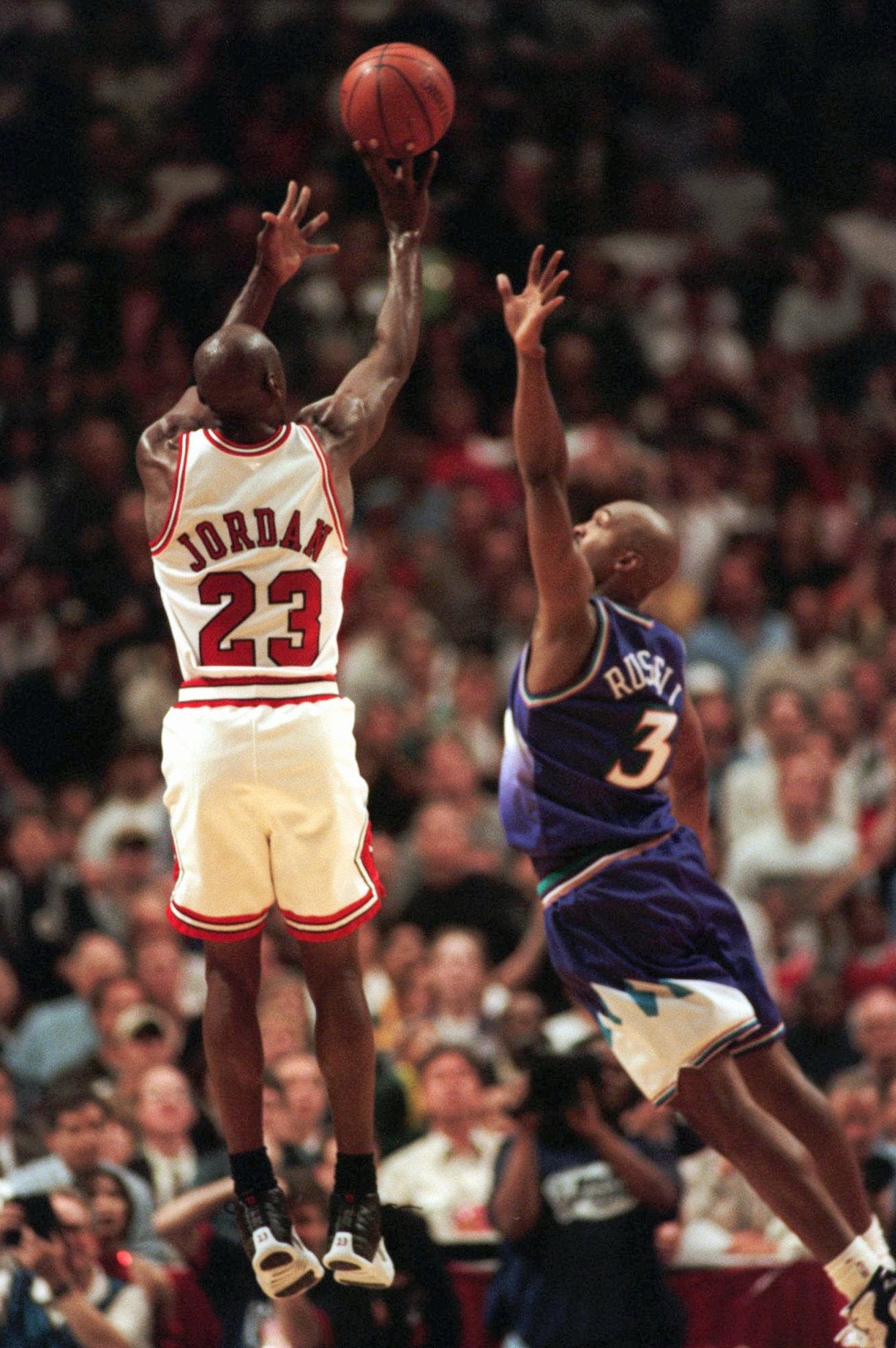(AP file photo) The Chicago Bulls' Michael Jordan puts up the game-winning shot over Utah Jazz forward Bryon Russell, right, to win Game 1 of the  NBA Finals 84-82 Sunday, June 1, 1997, in Chicago. A year later, Jordan did the same thing against Russell in Game 6 of the '98 Finals, hitting the game-winner at the Delta Center.