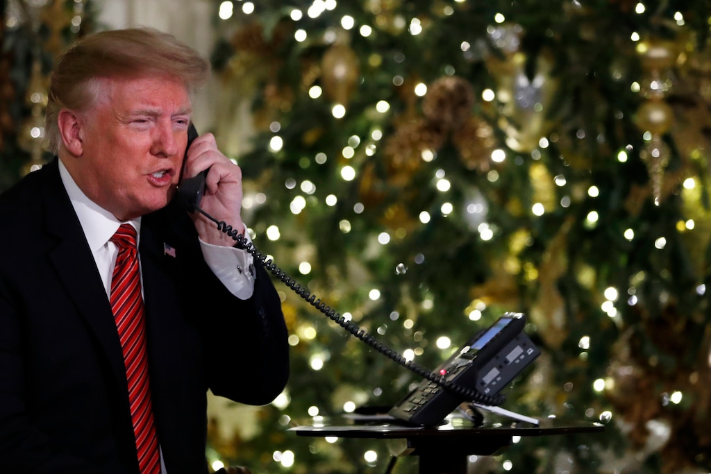 President Donald Trump speaks on the phone sharing updates to track Santa's movements from the North American Aerospace Defense Command (NORAD) Santa Tracker on Christmas Eve, Monday, Dec. 24, 2018. (AP Photo/Jacquelyn Martin)