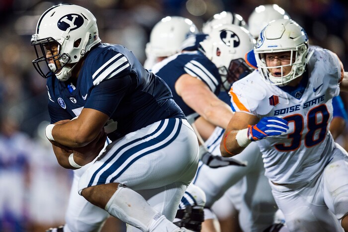 (Chris Detrick  |  The Salt Lake Tribune)  Brigham Young Cougars running back Ula Tolutau (5) runs past Boise State Broncos linebacker Leighton Vander Esch (38) during the game LaVell Edwards Stadium Friday, October 6, 2017. 