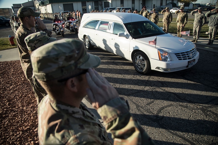 (Matt Herp | The Ogden Standrad Examiner/Pool) Utah National Guard members salute as a hearse containing the remains of Maj. Brent R. Taylor is escorted out of Roland R. Wright Air National Guard Base in Salt Lake City, Utah, on Wednesday, Nov. 14, 2018. Taylor, 39, of North Ogden, died Nov. 3, 2018, in Afghanistan of wounds sustained from small arms fire. His funeral is scheduled for Saturday, Nov. 17, in Ogden.