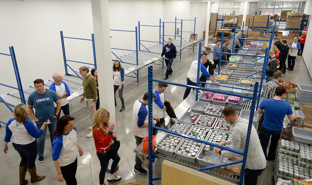 (Francisco Kjolseth  |  The Salt Lake Tribune)  USANA staff volunteer their time assembling food bags for at-risk youth at the newly-renovated packing and storage facility next to the headquarters of the Salt Lake City company on Wed. Dec. 11, 2019. The USANA Foundation has acquired two local charities, Kids Next Door and KidsEat!, that provides hundreds of food bags every week for the kids for the weekends and during long school breaks.