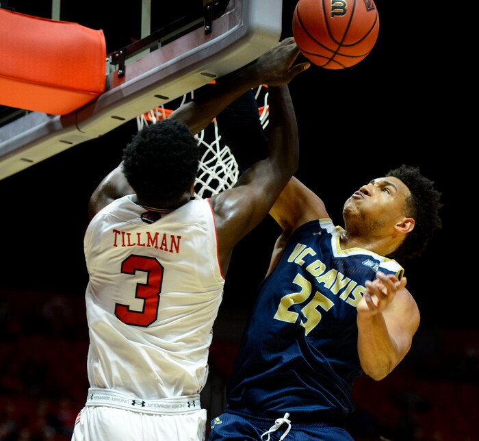 (Steve Griffin  |  The Salt Lake Tribune)  Utah Utes forward Donnie Tillman (3) gets fouled by UC Davis Aggies forward A.J. John (25) during the Utah versus UC Davis men's NIT basketball game at the Hunstman Center in Salt Lake City Wednesday March 14, 2018.