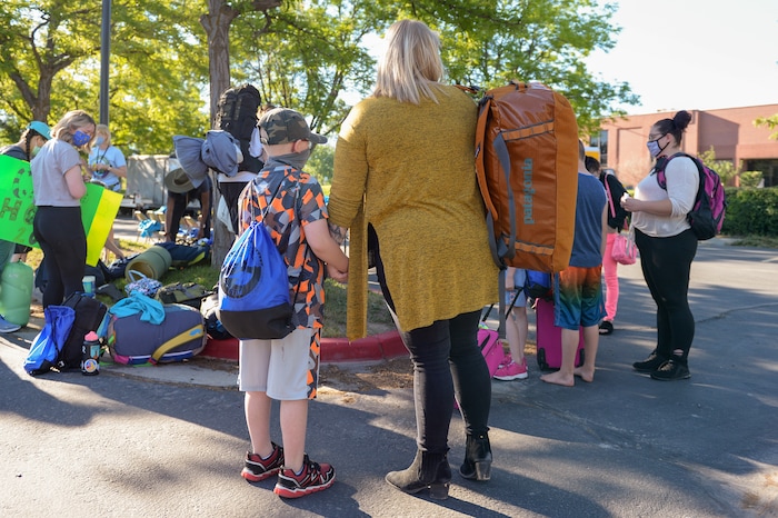 (Chris Samuels | The Salt Lake Tribune) Teal LaRoque holds her son’s hand before leaving for Camp Hope, a camp run by the Salt Lake District Attorney’s office for kids who have been victims of violence, Monday, June 28, 2021.