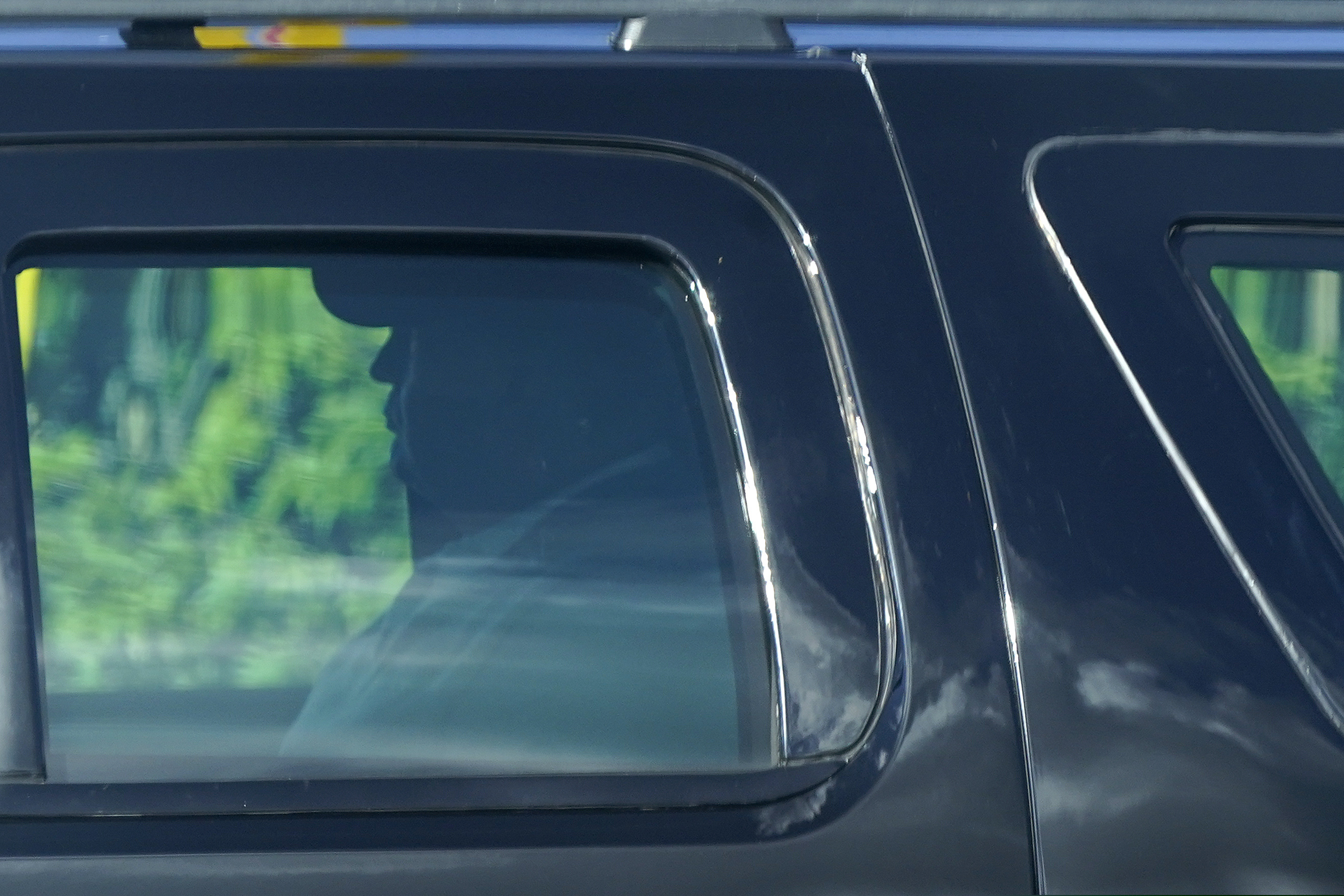 (Patrick Semansky | AP)  President Donald Trump rides in a motorcade vehicle as he departs his Mar-a-Lago resort, Sunday, Dec. 27, 2020, in Palm Beach, Fla. Trump is en route to Trump International Golf Club in West Palm Beach, Fla.