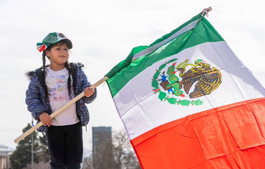 (Rick Egan | The Salt Lake Tribune) Kendra Martinez, 5, waves a flag during the national Day Without Immigrants rally on the steps of Capitol, on Monday, Feb. 14, 2022.