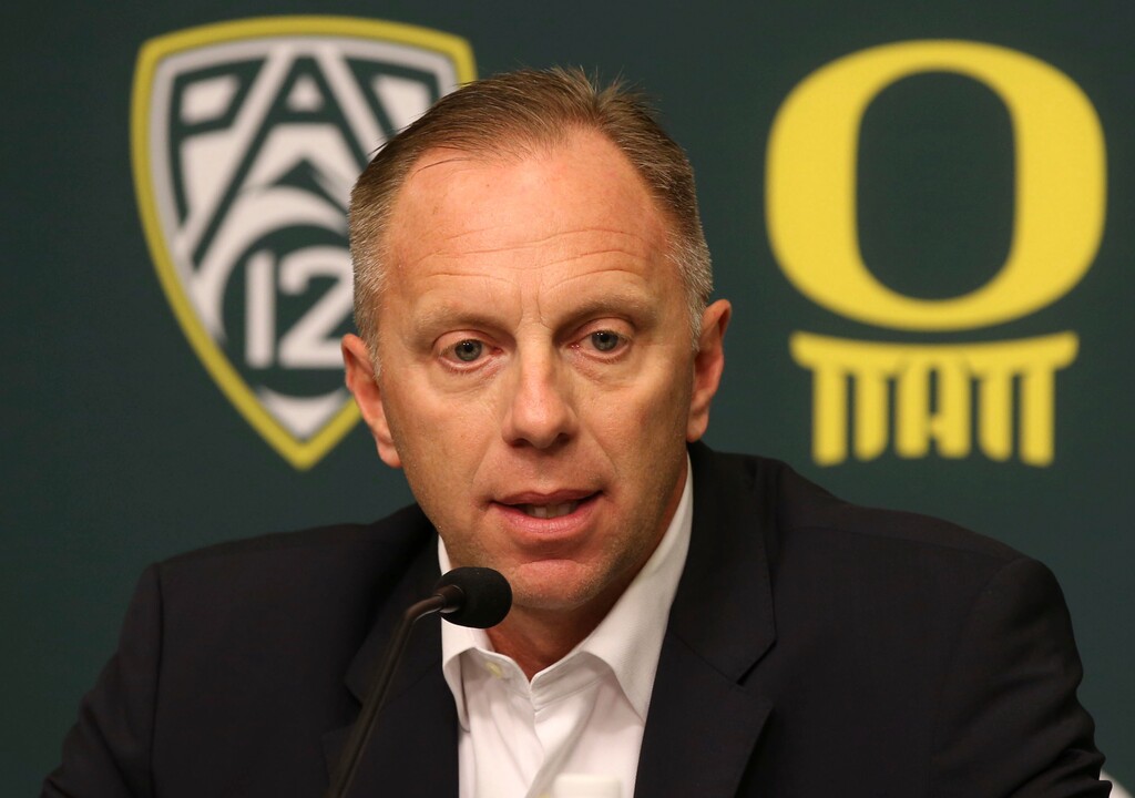 FILE - In this Nov. 29, 2016, file photo, Oregon athletic director Rob Mullens talks to the media in Eugene, Ore., after the firing NCAA college football head coach Mark Helfrich. Mullens will become the new chairman of the College Football Playoff selection committee starting next season, and three new Power Five ADs will join the 13-member panel. (Chris Pietsch/The Register-Guard via AP, File)