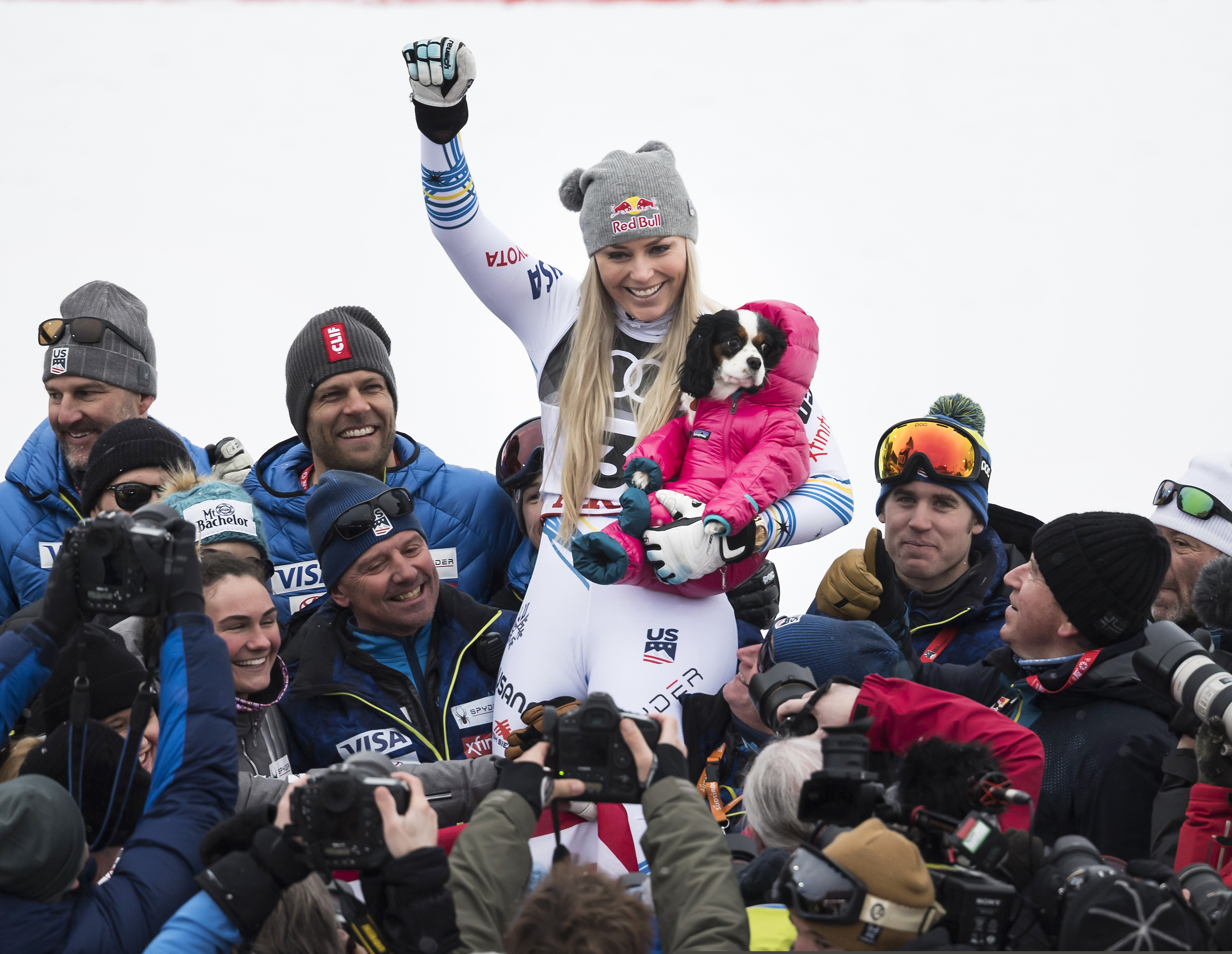 Lindsey Vonn of the United States celebrates with the dog Lucy after the flower ceremony of the women downhill race at the 2019 FIS Alpine Skiing World Championships in Are, Sweden Sunday, Feb. 10, 2019. (Jean-Christophe Bott/Keystone via AP)