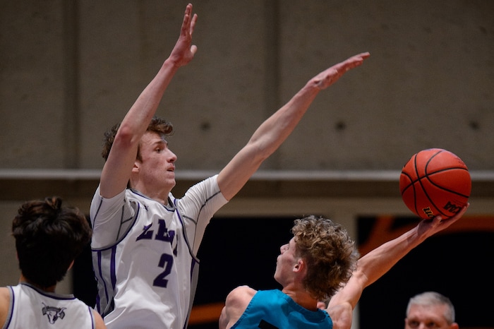 (Trent Nelson | The Salt Lake Tribune) Farmington's Collin Chandler is defended by Lehi's Tyson Hawkins as Lehi defeats Farmington High School in the 5A boys basketball state championship game, in Taylorsville on Saturday, March 6, 2021.