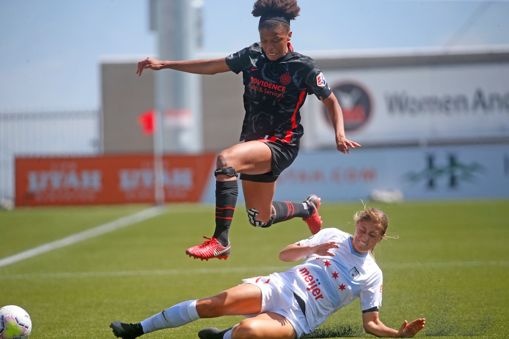 (Rick Bowmer | AP) Portland Thorns FC forward Simone Charley, above, leaps over Chicago Red Stars defender Hannah Davison, bottom, during the first half of an NWSL Challenge Cup soccer match at Zions Bank Stadium on Wednesday, July 1, 2020, in Herriman.