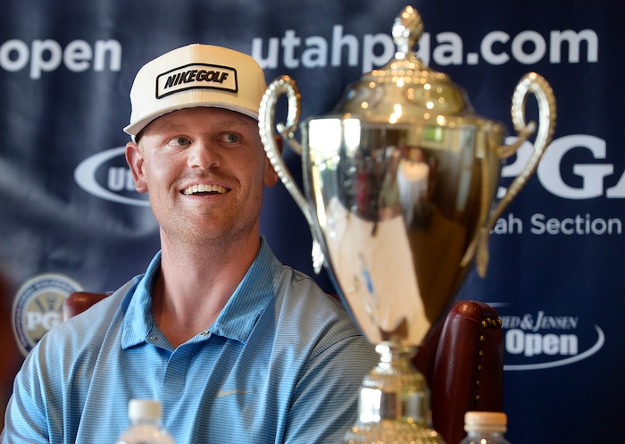 (Scott Sommerdorf | The Salt Lake Tribune)
Patrick Fishburn relaxes with his trophy after winning the Utah Open golf tournament played at the Riverside Country Club, Sunday, August 27, 2017. Fishburn crushed the field, with a 26 under score, nine strokes ahead of second place finisher Zahkai Brown at -17.