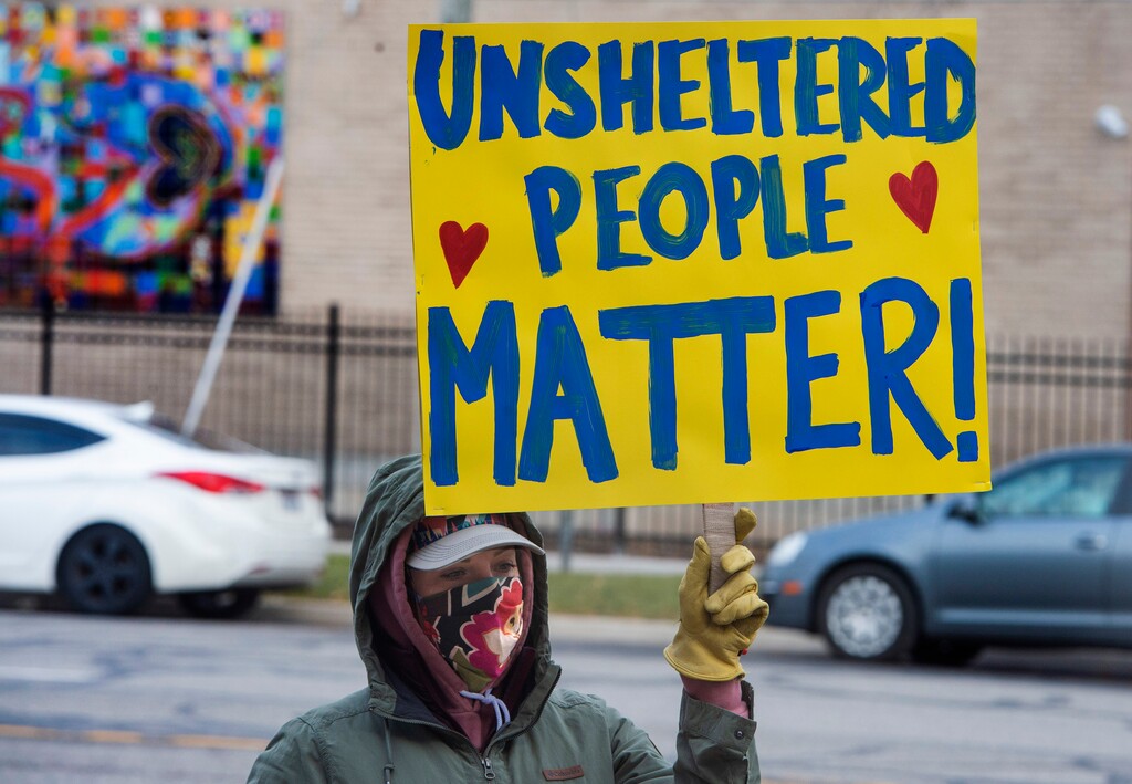 (Rick Egan | The Salt Lake Tribune)  A protester joins Black Lives Matter and other groups to protest the way the health department has been forcing people experiencing homelessness to move in the middle of a pandemic and the coldest time of the year, in front of the Salt Lake Public Health Center on Friday, Dec. 18, 2020.