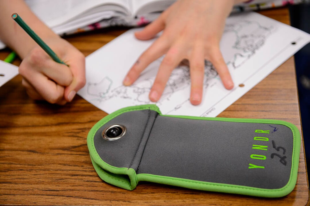 (Trent Nelson | The Salt Lake Tribune) Students in Monta Thomas' classes at Brighton High School in Cottonwood Heights secure their phones in locking pouches made by Yondr.