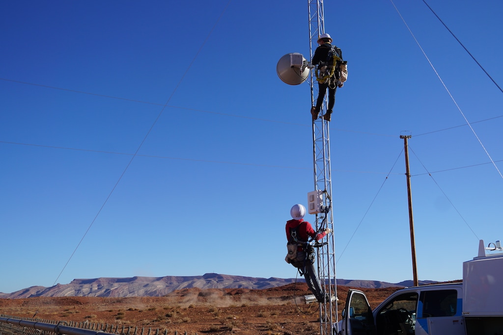(Zak Podmore | The Salt Lake Tribune) Tower technicians Nathan Berry, above, and Jory Christiansen work to bring internet to students in the Navajo Nation community of Halchita on Dec. 8, 2020. The tower was installed this fall with CARES Act funds and will receive a signal from a larger tower on distant Raplee Ridge.