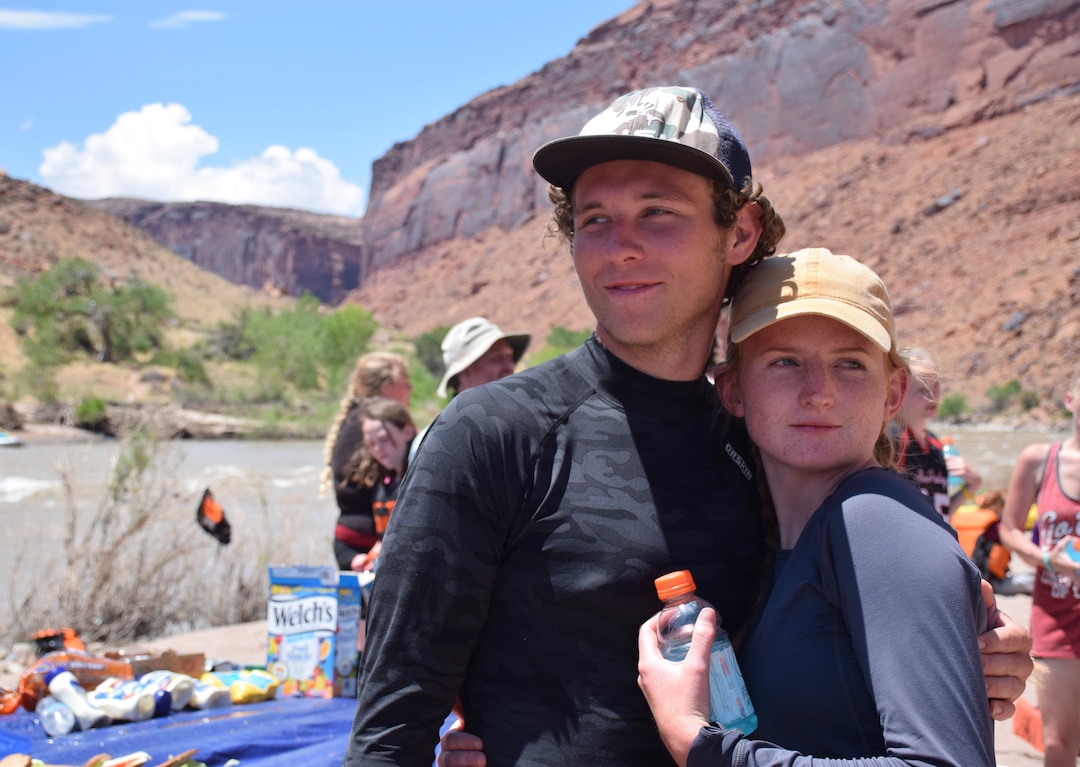 (Shannon Mullane for High Country News) Evan Thompson and Tianna Foster-Thompson, a young married couple, find a brief pause together after the picnic on the Colorado River rafting trip on July 27, 2019.