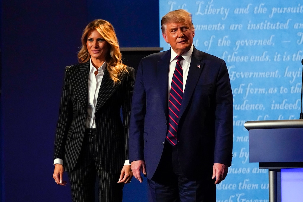 (Julio Cortez | AP) President Donald Trump stands on stage with first lady Melania Trump after the first presidential debate with Democratic presidential candidate former Vice President Joe Biden Tuesday, Sept. 29, 2020, at Case Western University and Cleveland Clinic, in Cleveland, Ohio. Both Trump and the first lady tested positive for COVID-19.