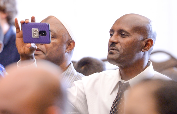 Leah Hogsten | The Salt Lake Tribune Terefe Mekonnen videos his sons Michael and Biruk as they receive their citizenship papers as America's newest citizens during a youth naturalization ceremony at the Viridian Event Center in West Jordan, Monday, August 6, 2018.