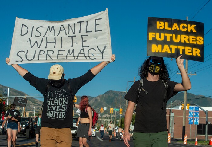 (Rick Egan  |  The Salt Lake Tribune)   Protesters carry signs as they march in the streets of Salt Lake City, during the Dance Dance Revolution protest for racial equality, on Sunday, Aug. 9, 2020.