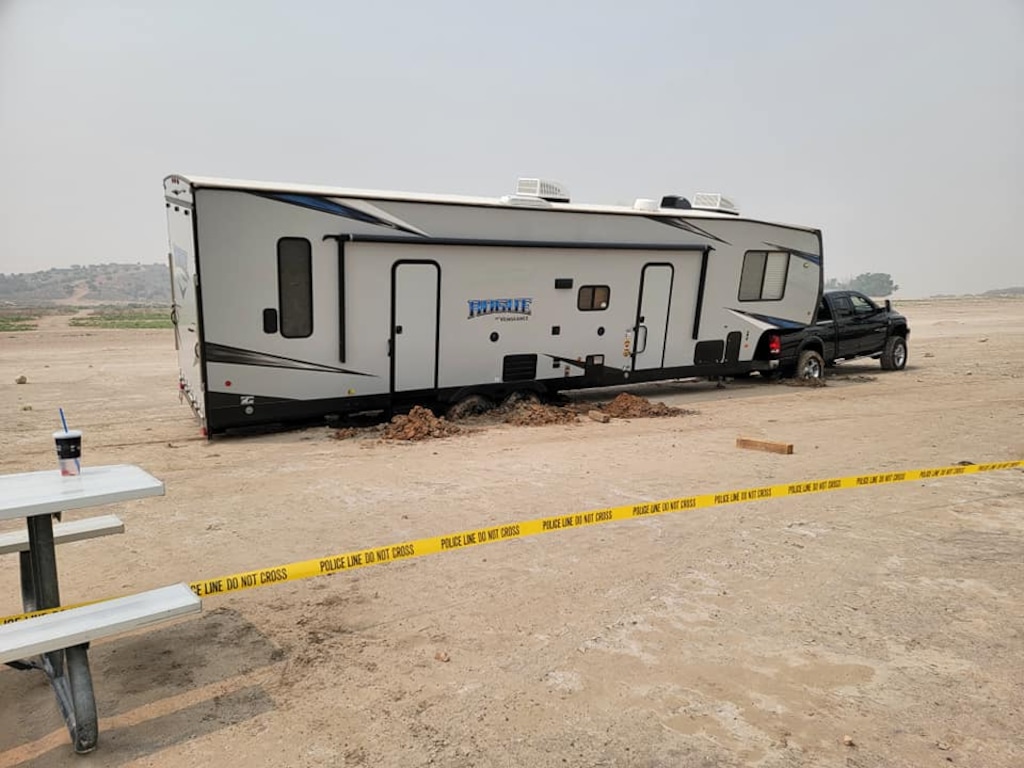 (Yuba State Park) A truck towing a large recreational trailer sits stuck in the mud at Yuba State Park in Juab County.