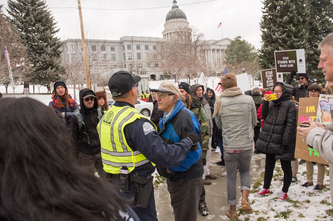 (Rachel Molenda  |  The Salt Lake Tribune)  A police officer separates protesters and a Trump supporter outside the capitol building in Salt Lake City, Utah, on Monday, December 4, 2017.
