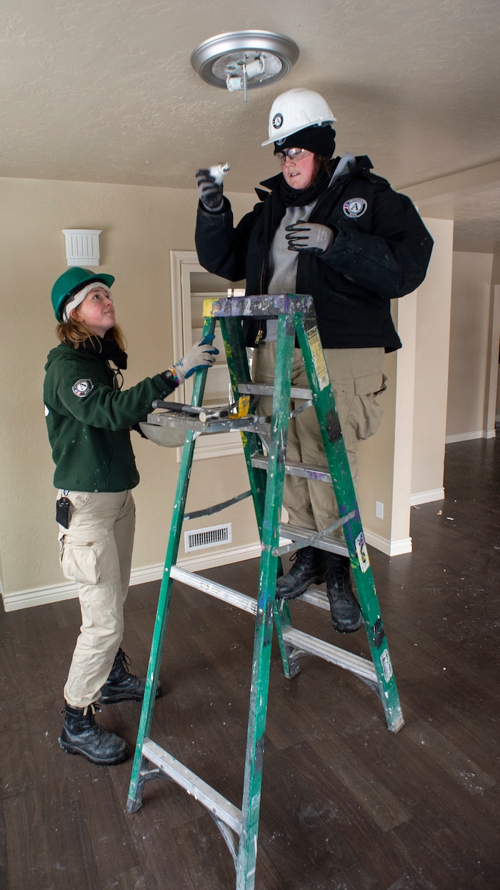 (Rick Egan  |  The Salt Lake Tribune)       
Meghan Schwob and Alex Elliott  remove light fixtures from a home that will be demolished for freeway widening, for UDOT and Habitat for Humanity, Wednesday, Jan. 16, 2019.






