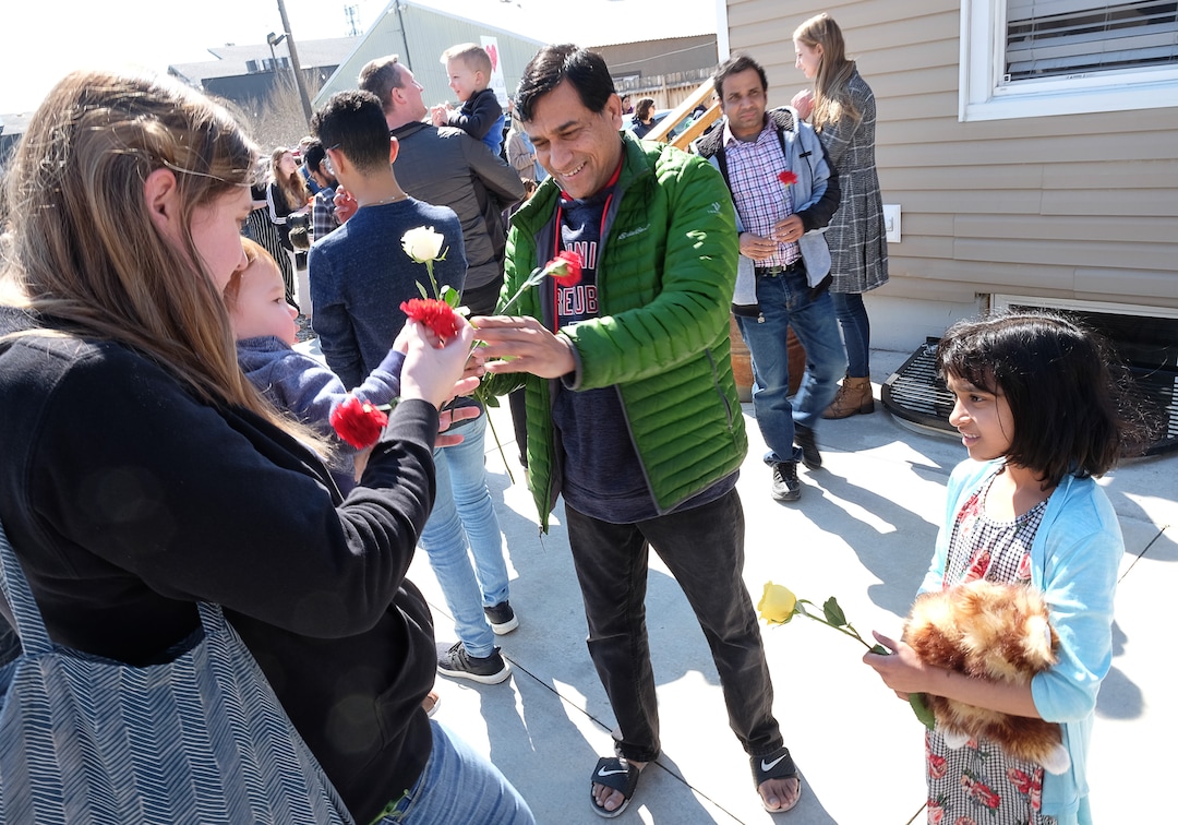(Francisco Kjolseth  |  The Salt Lake Tribune)  Muhahed Shaikh is joined by his daughter Maryam, 8, as they receive flowers from the community following Friday prayers services at the Al Sahaba Mosque in Orem in a show of love and support following the tragic shootings in New Zealand. 