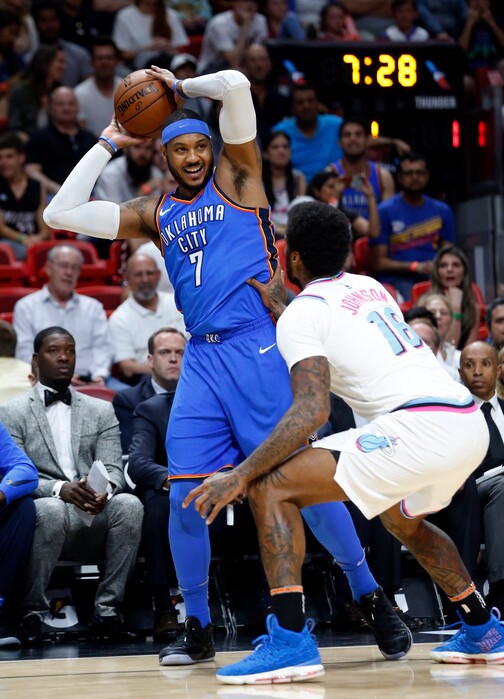 Oklahoma City Thunder forward Carmelo Anthony (7) looks for an open teammate past Miami Heat forward James Johnson (16) during the first half of an NBA basketball game, Monday, April 9, 2018, in Miami. (AP Photo/Wilfredo Lee)