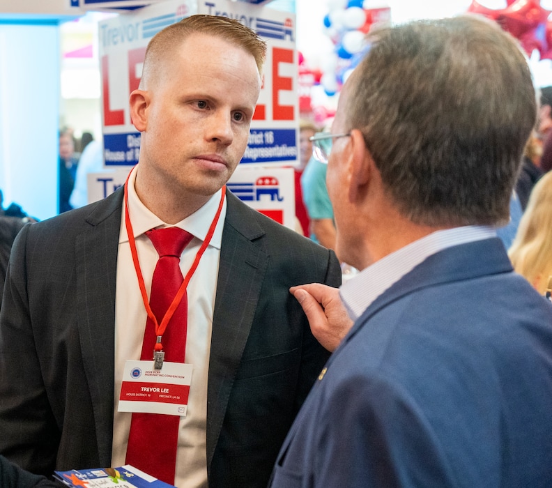 (Rick Egan | The Salt Lake Tribune)  Trevor Lee speaks with Senate President Stuart Adams, at the Davis County Republican nominating convention at Farmington High School, on Saturday, March 26, 2022. Utah House GOP leaders have rebuked Lee for anonymous posts he made on Twitter that attacked LGBTQ people and criticized Gov. Spencer Cox for his support of transgender girls.