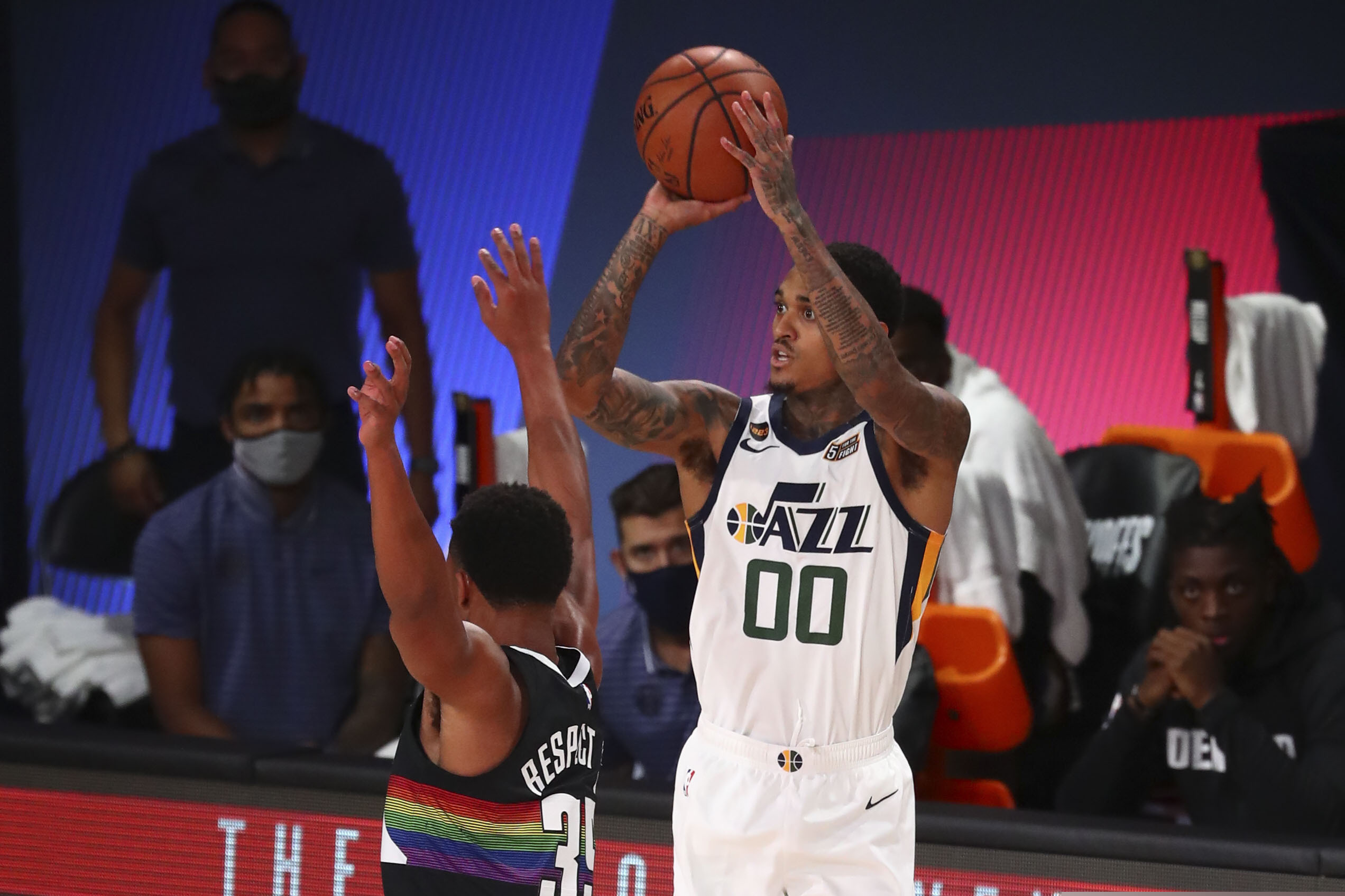 Utah Jazz guard Jordan Clarkson (00) shoots the basketball against Denver Nuggets guard PJ Dozier (35) in game Game 2 of an NBA basketball first-round playoff series, Wednesday, Aug. 19, 2020, in Lake Buena Vista, Fla. (Kim Klement/Pool Photo via AP)