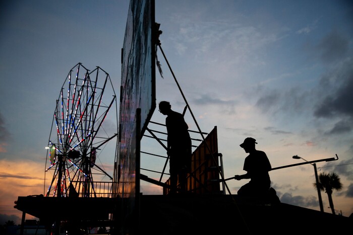 (David Goldman | The Associated Press)  Workers dismantle the facade of a funhouse at an amusement park ahead of Hurricane Irma in Daytona Beach, Fla., Thursday, Sept. 7, 2017. South Florida officials are expanding evacuation orders as Hurricane Irma approaches, telling more than a half-million people to seek safety inland.