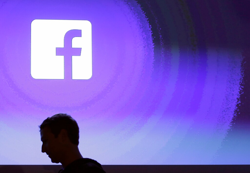 FILE - In this April 4, 2013 file photo, Facebook CEO Mark Zuckerberg walks at the company's headquarters in Menlo Park, Calif. Facebook said Tuesday, Aug. 21, 2018, that it had removed 652 pages, groups, and accounts linked to Russia and Iran for “coordinated inauthentic behavior” that included the sharing of political content amid stepped-up policing of its own platform ahead of the U.S. midterm elections in November. (AP Photo/Marcio Jose Sanchez, File)