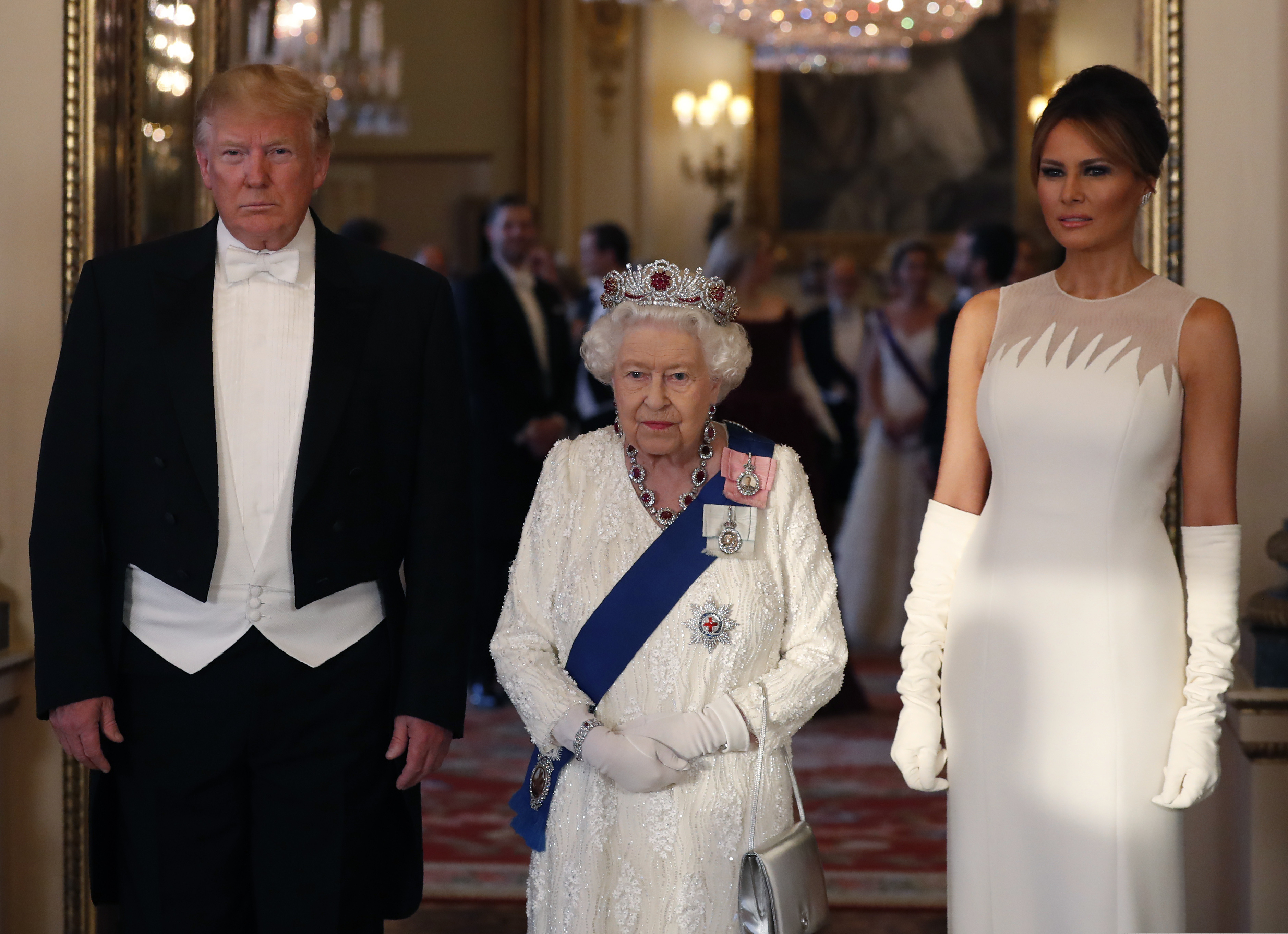 Britain's Queen Elizabeth II, centre poses for a photo with US President Donald Trump, left and first lady Melania Trump ahead of the State Banquet at Buckingham Palace in London, Monday, June 3, 2019. Trump is on a three-day state visit to Britain. (AP Photo/Alastair Grant, Pool)