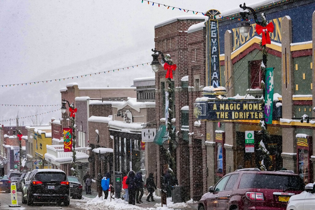 (Francisco Kjolseth | The Salt Lake Tribune) People visit historic Main Street in Park City on Thursday, Dec. 30, 2021, walking past the Egyptian Theatre — one of the major venues of the Sundance Film Festival. The theater will again sit dark during Sundance, after officials canceled the in-person portion of the festival because of the COVID-19 pandemic.