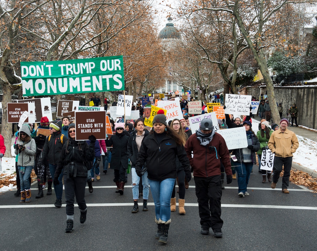 (Rick Egan  |  The Salt Lake Tribune)  Thousands of protesters turn their backs and march down State, as President Trump speaks at the Utah State Capitol, during his visit to Salt Lake CIty, Monday, December 4, 2017.