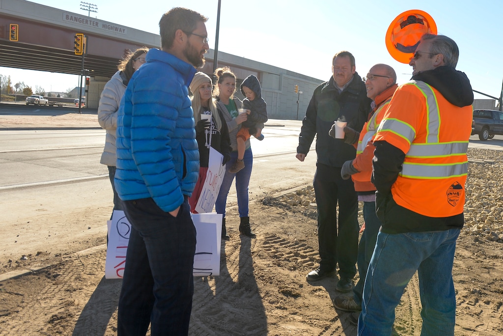 (Leah Hogsten | The Salt Lake Tribune) Brent Jakobson, wife Elena Jakobson and their neighbors who live on New Heritage Drive in West Jordan protested the completion of a $208 million project that converted four intersections into freeway-like interchanges at 5400 South, 7000 South, 9000 South and 11400 South. They complain that while a new sound wall being built at the 9000 South interchange will tower 11 feet above Bangerter, it will only be a couple of feet tall in their back yards which are at a much higher elevation — saying that creates a danger for children in the area, and also may not do much to reduce noise.