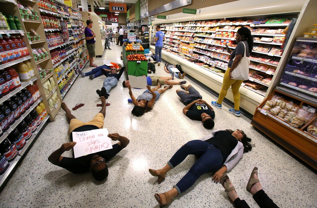 Demonstrators lie on the floor during a protest against gun violence, at the Publix store on East Colonial Drive near downtown Orlando, Fla., Friday, May 25, 2018. The Orlando demonstration was one of numerous across the state after anti-gun activist David Hogg called for a coordinated demonstration. Hogg is a student at Marjory Stoneman Douglas High School in Parkland, where a gunman killed 17 students and faculty on Feb. 14. (Joe Burbank /Orlando Sentinel via AP)