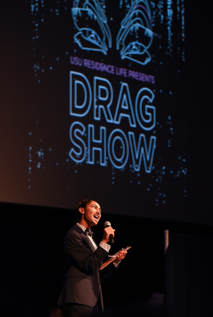 (Francisco Kjolseth  |  The Salt Lake Tribune)  Alexis Cooper, a Utah State University student who won the Miss USU pageant competition last year, gets the crowd excited for the schools very first drag show recently. With a spirited presence, Cooper played the role of Adonis as the emcee to a packed ballroom at the Taggart Student Center, introducing ten drag queens and kings to a friendly and excited crowd. 
