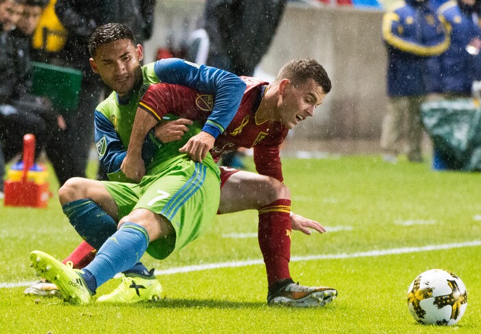 (Rick Egan  |  The Salt Lake Tribune)  Real Salt Lake forward Brooks Lennon (27) gets tangled up with Seattle Sounders midfielder Cristian Roldan (7), as he goes for the ball, in MLS soccer action, Real Salt Lake vs Seattle Sounders, in Sandy, Utah, Saturday, September 23, 2017.