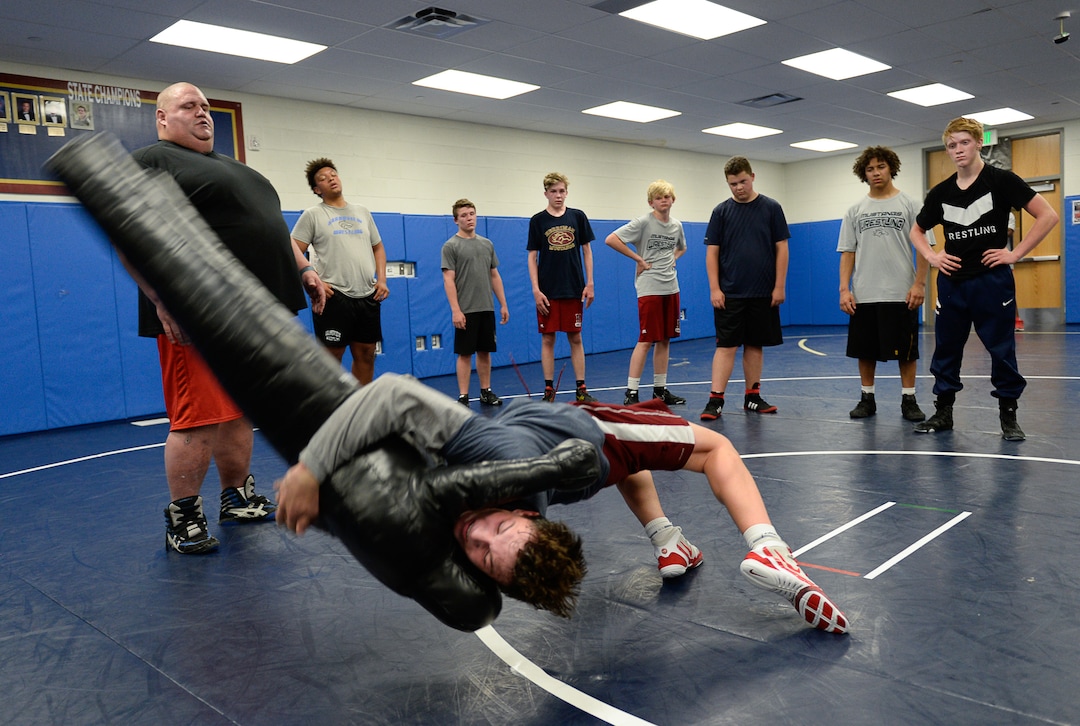(Francisco Kjolseth  |  The Salt Lake Tribune)  Talmage Carmen, 15, "throws the dummy," a 50 lbs throwing and pound dummy for drills as Olympic wrestling champion Rulon Gardner runs an introductory clinic with young wrestlers at Herriman High School after being introduced as the new coach on Wed. May 17, 2018. Gardner a retired Greco-Roman wrestler won the gold medal in 2000 and the bronze in 2004. 