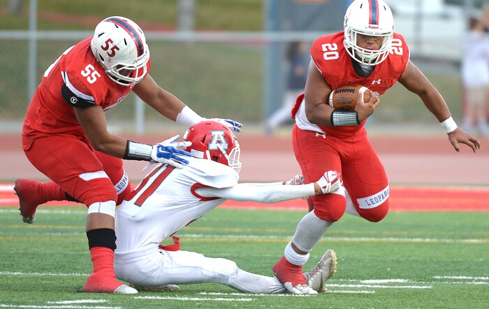 (Leah Hogsten  |  The Salt Lake Tribune) East's Hailame Feletoa slips past the Cavemen defense. American Fork High School boys' football team East High School during their class 6A state quarterfinal football game, Friday, November 3, 2017