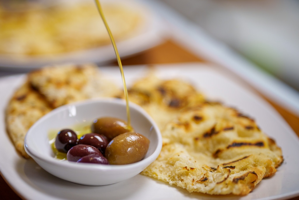 (Trent Nelson  |  The Salt Lake Tribune) Psomi — grilled pinsa bread with olives and olive oil — from Manoli's in Salt Lake City, one of the restaurants recommended by Xiao Bao Bao and Chez Nibs owner and chef Romina Rasmussen.