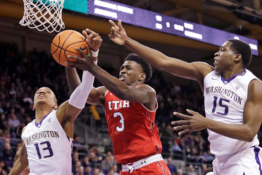 Utah's Donnie Tillman (3) reaches for a rebound between Washington's Hameir Wright (13) and Noah Dickerson (15) during the first half of an NCAA college basketball game Thursday, Feb. 15, 2018, in Seattle. (AP Photo/Elaine Thompson)