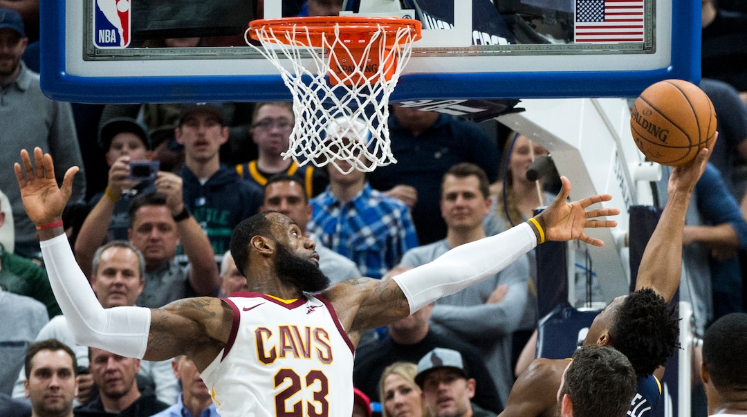 (Rick Egan  |  The Salt Lake Tribune)   Utah Jazz guard Donovan Mitchell (45) scores to pu the Jazz up  62-56, as Cleveland Cavaliers forward LeBron James (23) defends, in NBA action Utah Jazz vs Cleveland Cavaliers, in Salt Lake City,  Saturday, December 30, 2017.