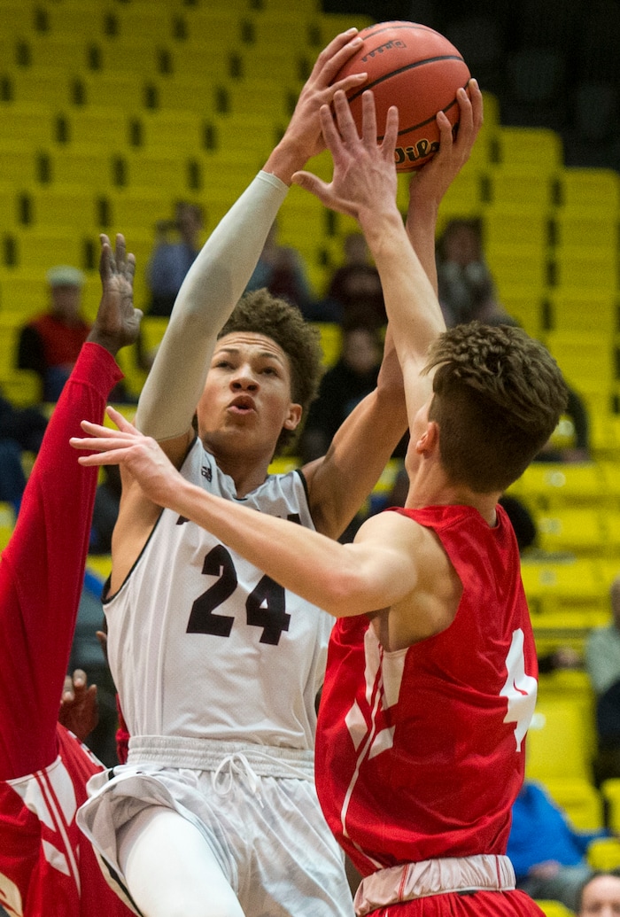 (Rick Egan  |  The Salt Lake Tribune)  Jordan Beatdiggers Terryn Mosley, takes a shot as East Leopards Taylor Zwick (4) defends, in 5A basketball playoff action between the East Leopards and the Jordan Beatdiggers at the UCCU Center in Orem, Monday, Feb. 26, 2018.