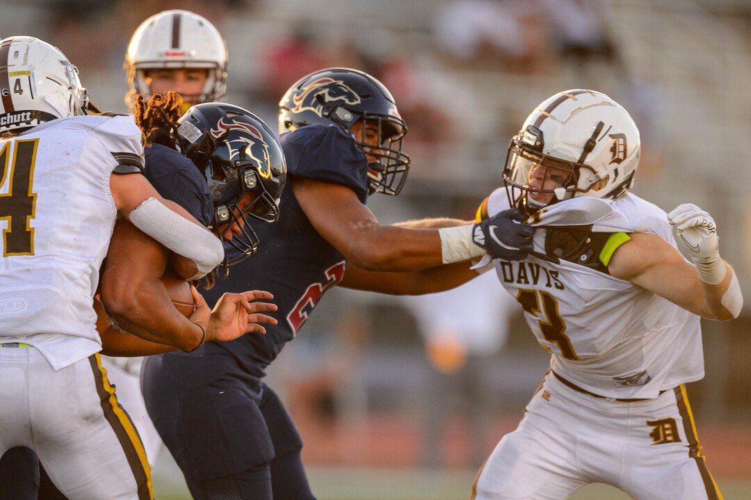 (Trent Nelson  |  The Salt Lake Tribune) Herriman's Nu'u Tafisi runs the ball as Herriman hosts Davis High School football, in Herriman on Thursday, Aug. 13, 2020.