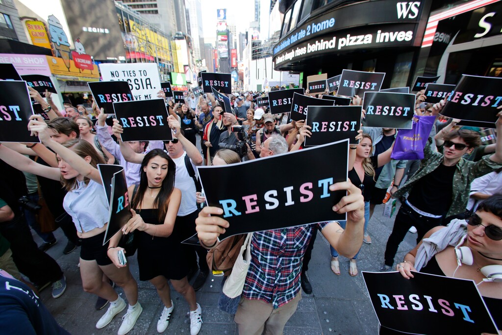 (Frank Franklin II | The Associated Press) Protestors gather in Times Square, Wednesday, July 26, 2017, in New York. President Donald Trump declared a ban Wednesday on transgender troops serving anywhere in the U.S. military, catching the Pentagon flat-footed and unable to explain what it called Trump's "guidance." His proclamation, on Twitter rather than any formal announcement, drew bipartisan denunciations and threw currently serving transgender soldiers into limbo.