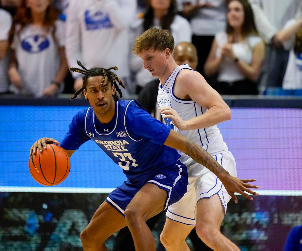 (Bethany Baker  |  The Salt Lake Tribune) Georgia State Panthers guard Lucas Taylor (31) is defended by Brigham Young Cougars guard Dawson Baker (25) as BYU hosts Georgia State in NCAA basketball in Provo on Saturday, Dec. 16, 2023.