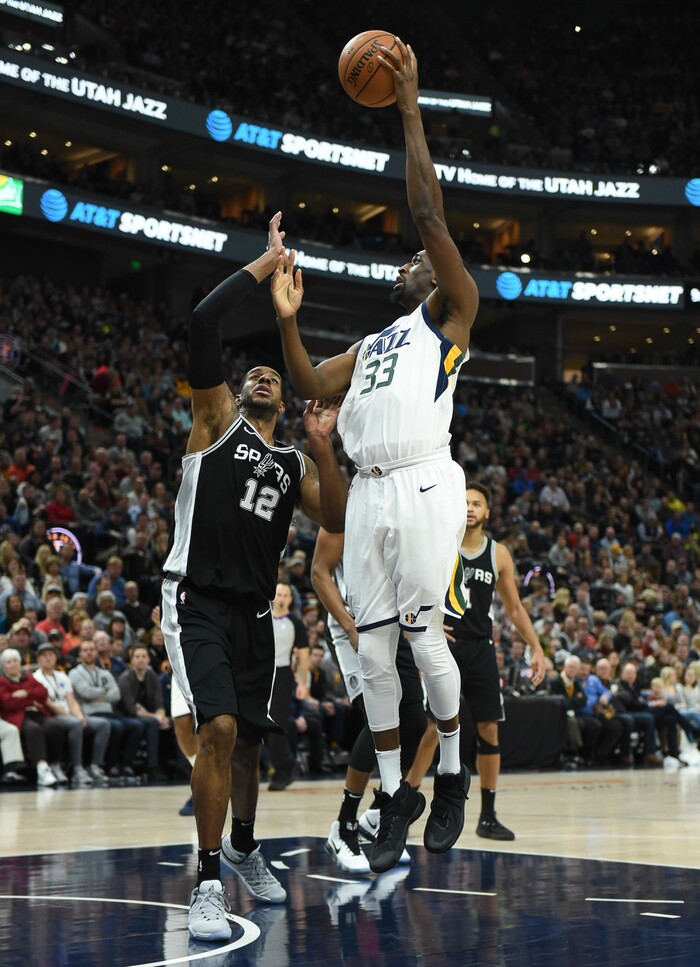 (Francisco Kjolseth  |  The Salt Lake Tribune)  Utah Jazz center Ekpe Udoh (33) stretches over San Antonio Spurs forward LaMarcus Aldridge (12) during the first quarter of an NBA basketball game in Salt Lake City, Thursday, Dec. 21, 2017.