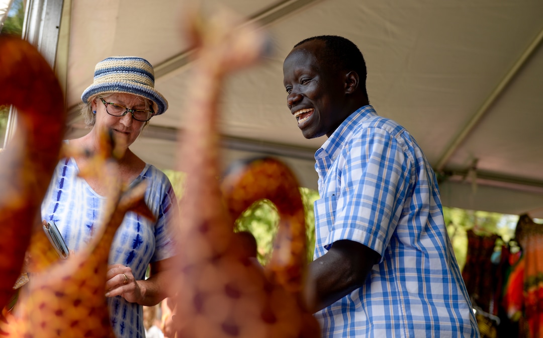 (Leah Hogsten  |  The Salt Lake Tribune)  Dominic Raimondo, right, sells an beaded bowl to Betsy Carson de Avila during the 4th Annual African Festival sponsored by the United Africans of Utah, Saturday, July 27, 2019 at Liberty Park. The African Festival promotes African tradition, culture and heritage through the arts, food fashion, music and dance. The Dominic Raimondo Foundation raises money for South Sudan refugees living in a refugee camp in Kenya.
